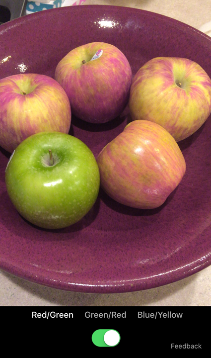 Color Binoculars enhanced photo of red and green apples.