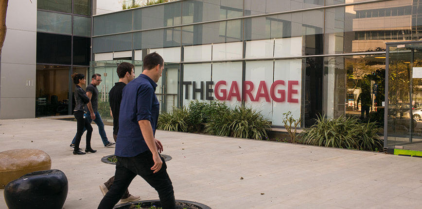 A group of people approach a building that houses the Microsoft Garage