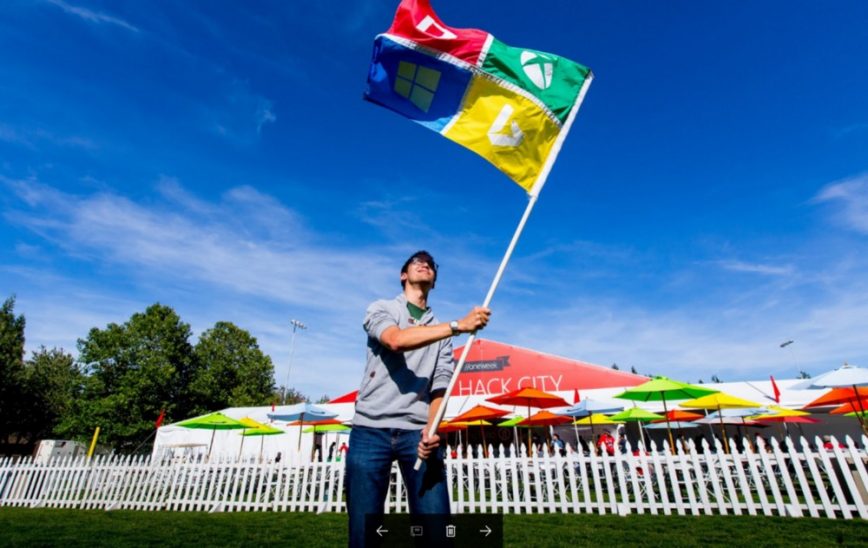 Man holding up a hackathon flag