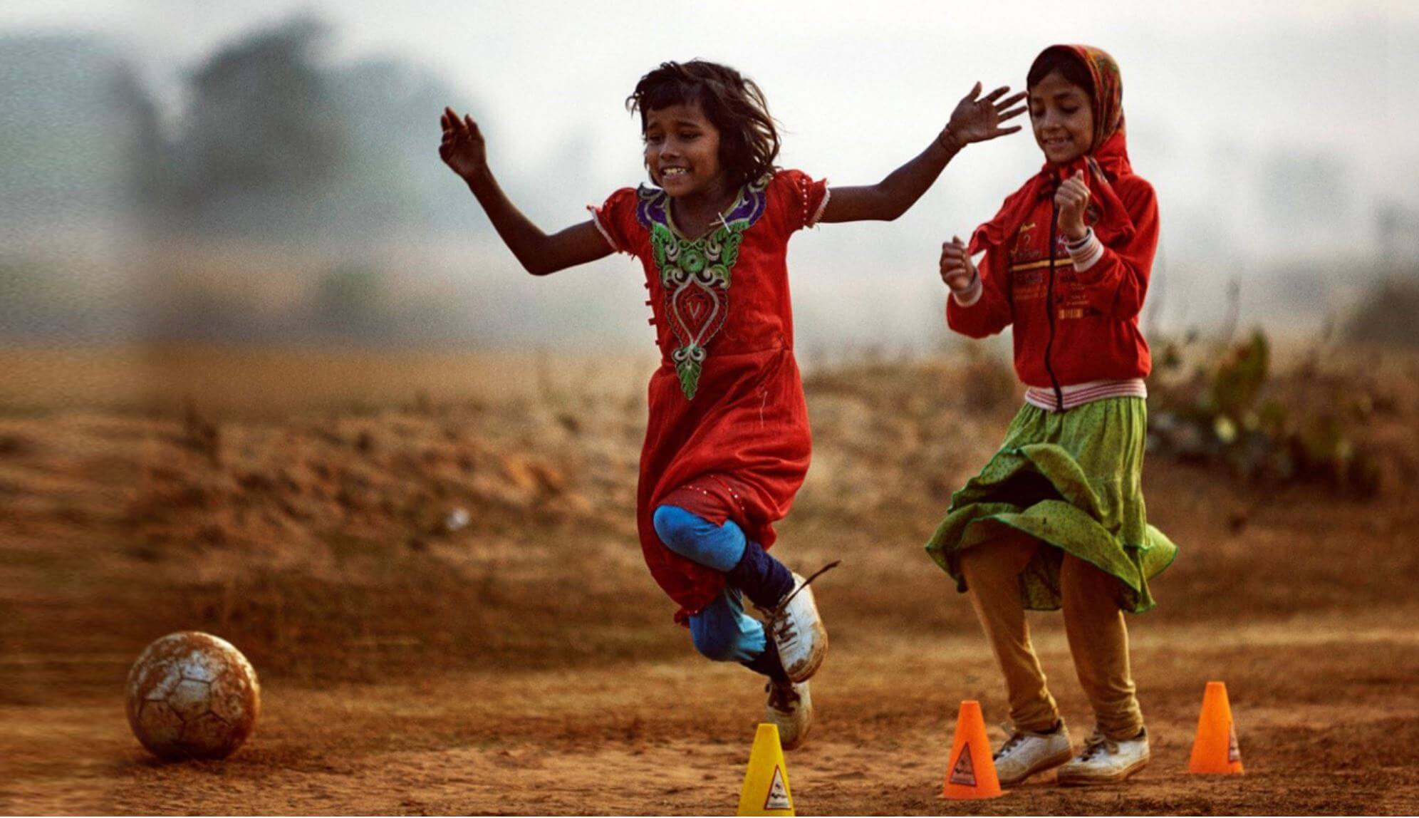 image of two girls playing soccer