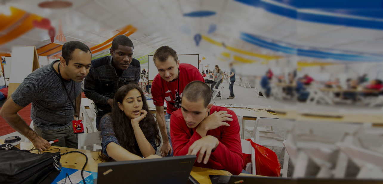 a group of people looking at a computer screen