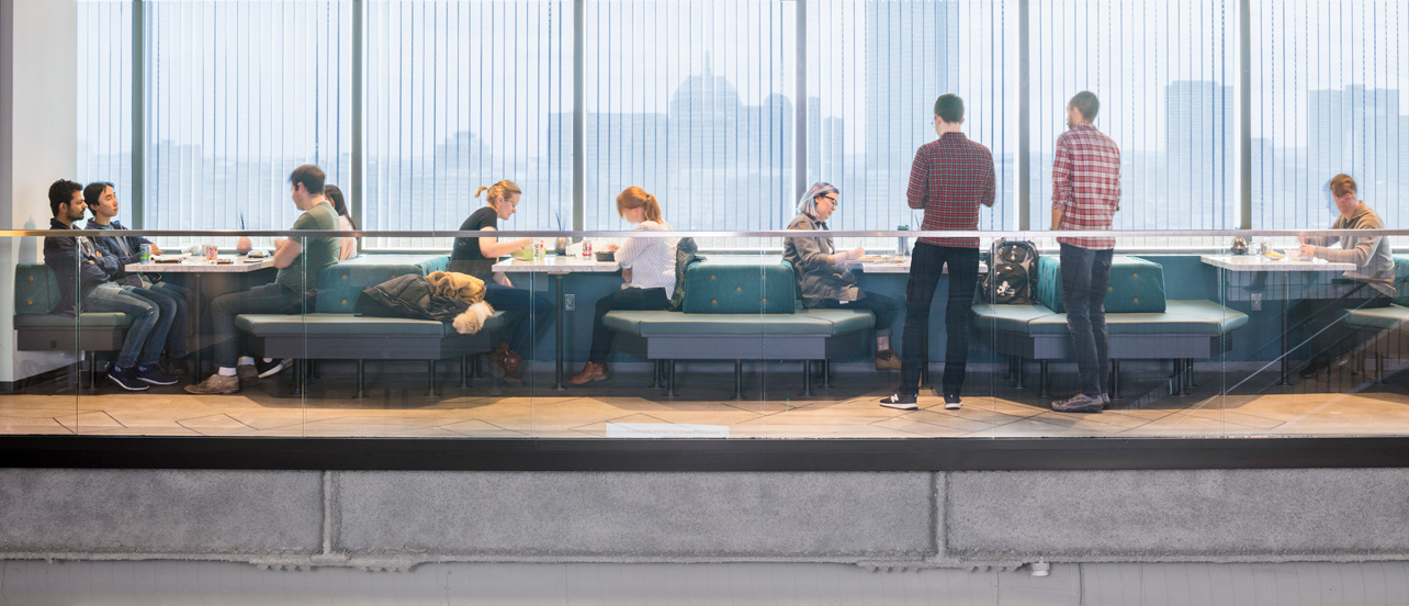 people having lunch at work with the Boston Skyline behind them