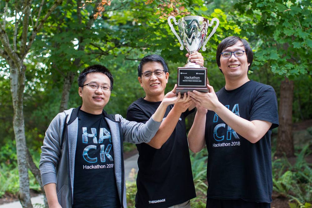 2018 Hackathon project winners hold trophy