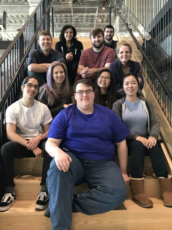 Photo of MIT externs at The Garage sitting on a staircase