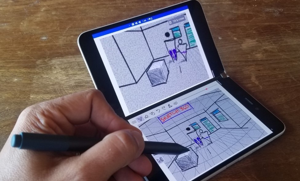 A man sketches a conference hall using the unique gridlines of Sketch 360 on Surface Duo