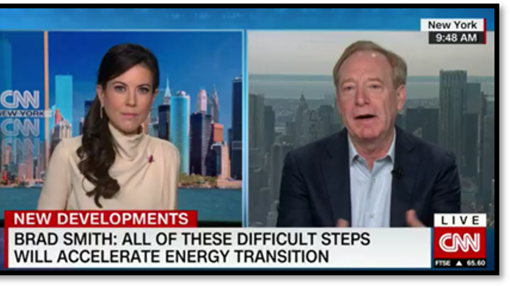 Microsoft Vice Chair and President Brad Smith speaks on CNN with a female reporter.